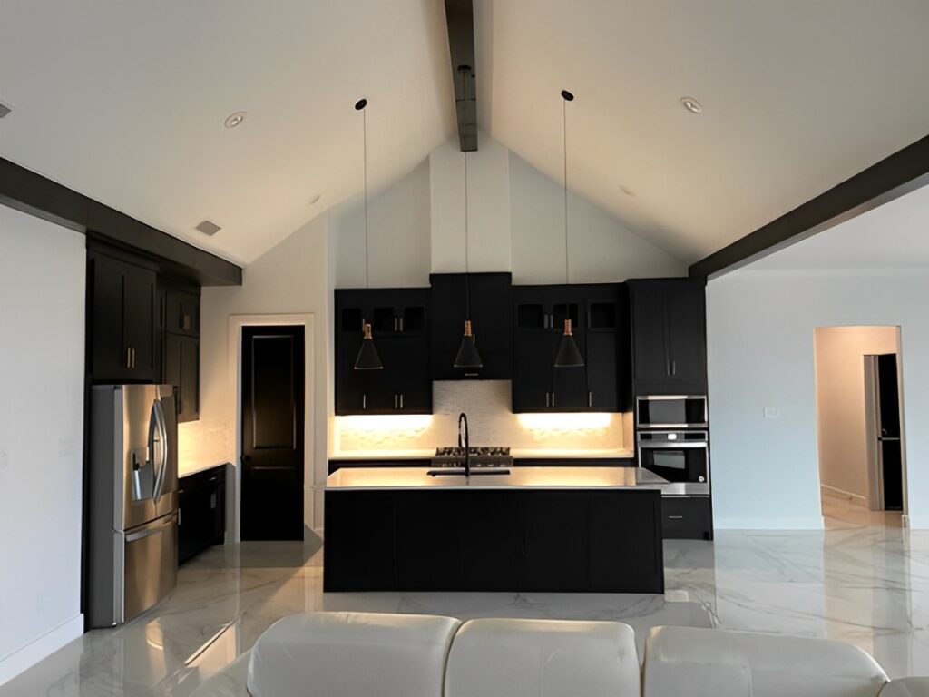 A Modern Kitchen Featuring a Sleek Black and White Color Scheme, Showcasing Stylish Cabinetry and Elegant Countertops.